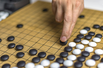 Fototapeta na wymiar Playing Go or Igo, Chinese board game