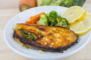 Grilled Salmon with fresh salad and lemon. Selective focus