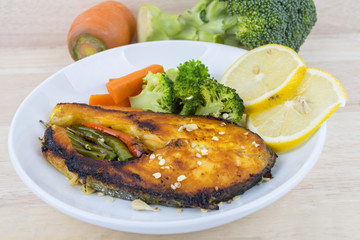 Grilled Salmon with fresh salad and lemon. Selective focus