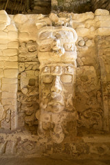 well preserved statue on the Temple of the Measks at Kohunlich maya archaeological site in Quintana Roo Mexico