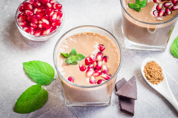 Healthy chocolate pomegranate banana peanut butter shake. Selective focus, close up.