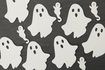 Halloween ghost shapes on a slate background