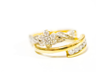 two diamond engagement rings on blurred background
