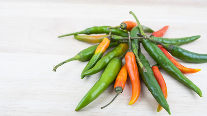Hot Chilli Peppers isolated on wood board background, close up. Selective focus
