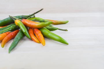 Hot Chilli Peppers isolated on wood board background, close up. Selective focus