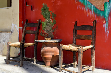 Two wooden chairs with a braided bottom