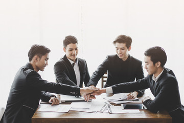 Group asia businessman together create a mutually beneficial business relationship. Economic graph on the table