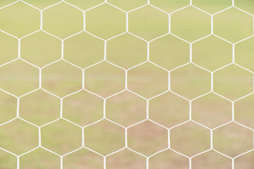 Pattern hexagon nets and goal at the footbal field for sport background