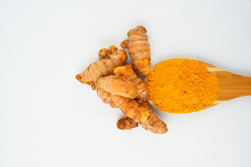 Turmeric powder and turmeric, bamboo ladle with isolated white background