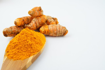 Turmeric powder and turmeric, bamboo ladle with isolated white background