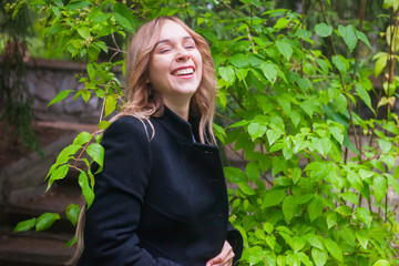 happy pregnant woman rests and smile in a garden, happy expecting of child