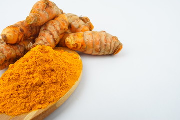 Turmeric powder and turmeric, bamboo ladle with isolated white background