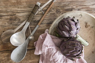 Stil life with kitchen utensils and artichokes