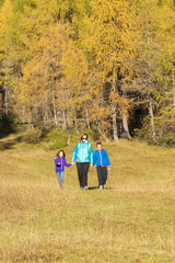 Active family spending time hiking in the colourful woods.