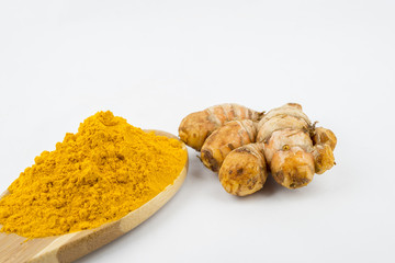 Turmeric powder and turmeric, bamboo ladle with isolated white background