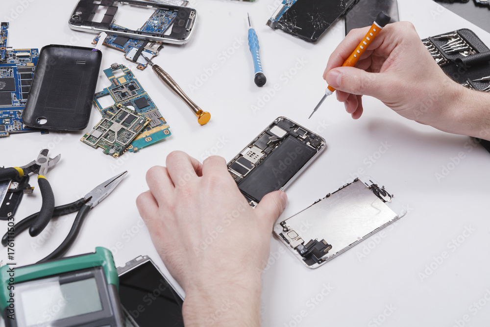 Poster repairman disassembling phone with screwdriver