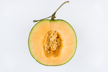 Close up view of a rock melon isolated on a white background.
