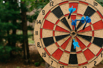 Darts in a dartboard outdoors