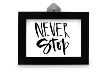 Never stop. Handwritten text. Modern calligraphy. Inspirational quote. Black photo frame