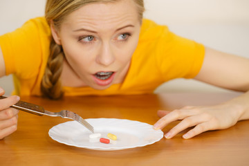 Fototapeta na wymiar Shocked woman having pills on plate