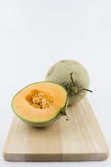 Close up view of a rock melon isolated on a white background.