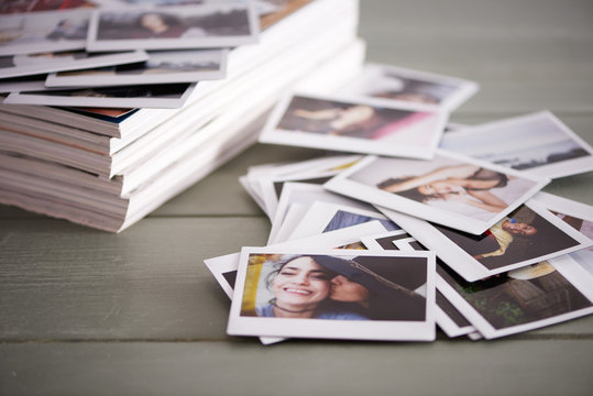A bunch of pictures magazines on a green wooden table