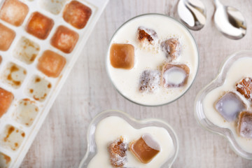 Milk cocktail with ice cubes with a form with a cubes top view