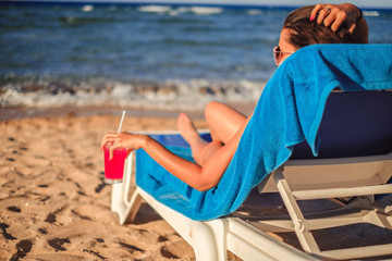 Fototapeta na wymiar Girl enjoying cocktail on the beach