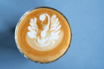 Coffee latte art on blue table background