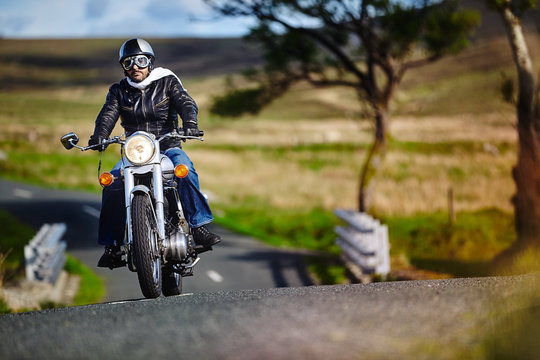 Caferacer biker going on a rural road