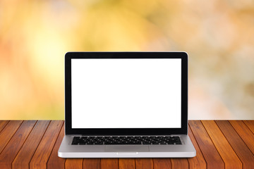 Front view of the laptop is on the work table with bokeh green background