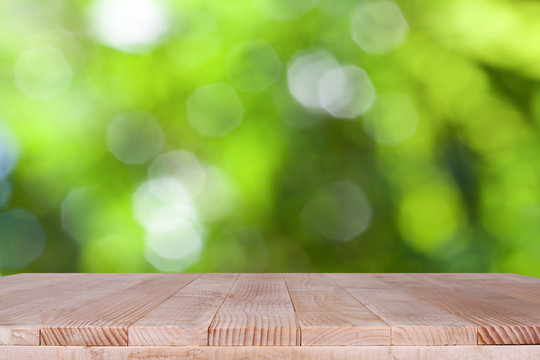 Wood table top on bokeh green background - can be used for montage or display your products