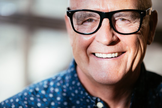Senior stylish man smiling portrait wearing glasses