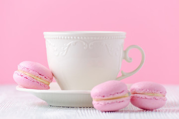 coffee cup on pink background, macaroons