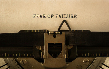 Text FEAR OF FAILURE typed on retro typewriter