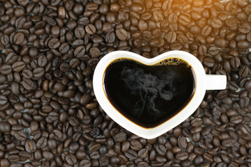 top view of coffee cup heart shape on coffee bean