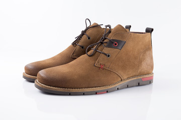 Male brown leather boot on white background, isolated product, comfortable footwear.