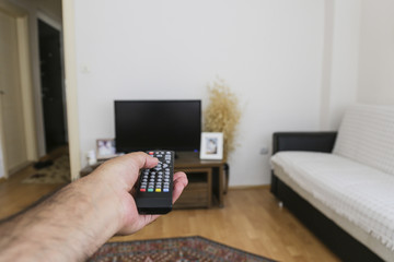 television remote control and hand 