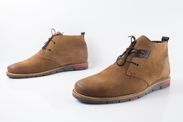 Male brown leather boot on white background, isolated product.