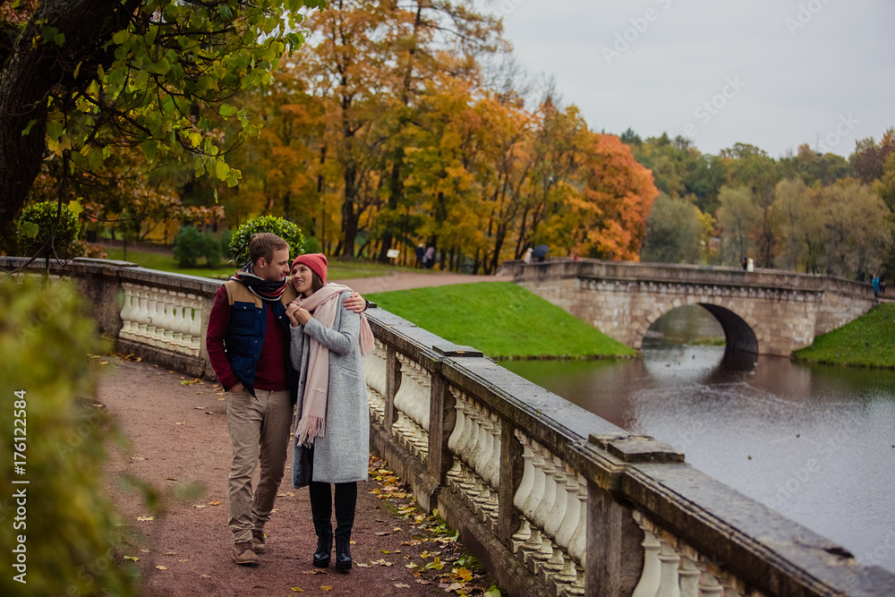 Wall mural Beautiful pair of lovers walking in the autumn Park