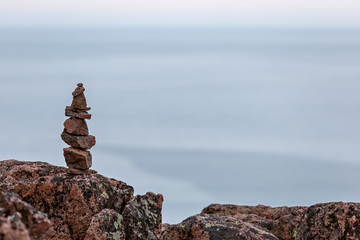 Built of stone inukshuk statue on the sea coast