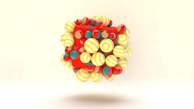 Impressive 3d rendering of colorful balls spinning around the central red box. The majority of them are striped big and small balls of white and yellow colors. The backdrop is white.