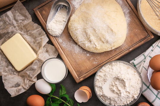Raw dough and ingredients on kitchen table