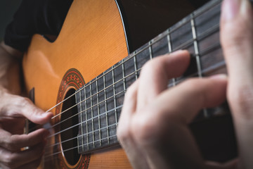 Obraz premium A man playing classical guitar.