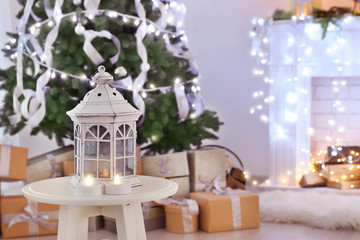 Lantern and candles in beautiful room with Christmas decorations