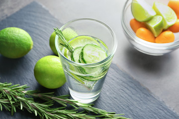 Glass with fresh rosemary drink on table