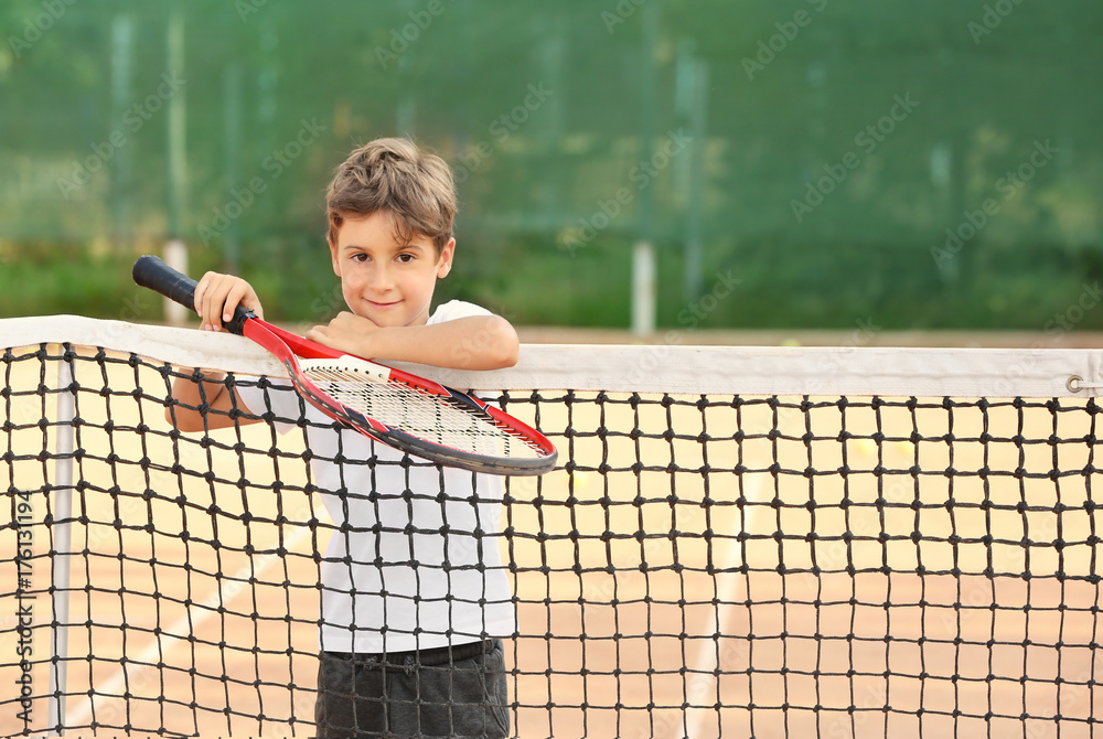 Sticker Cute little boy with tennis racket on court