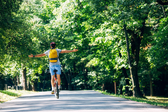 Man on a Bicycle Spreading Arms