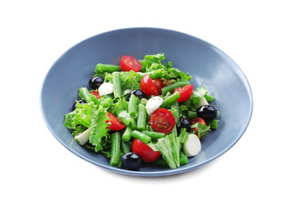 Plate of salad with green beans on white background
