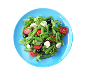 Plate of salad with green beans on white background
